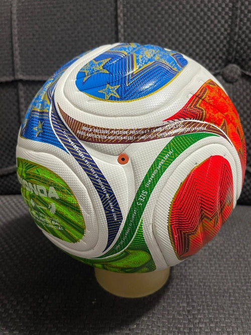 Colorful soccer ball with various symbols on a gray surface