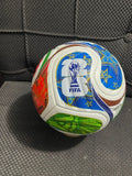 Soccer ball with colorful design on a black background
