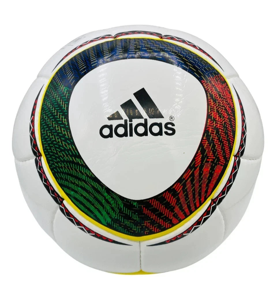 An Adidas soccer ball with a white base and a central graphic featuring green, red, and blue textured patterns with black Adidas branding.