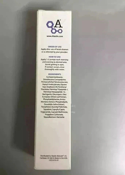 A tall, narrow white product box standing upright against a gray background, showing the back side with printed text and a purple logo.