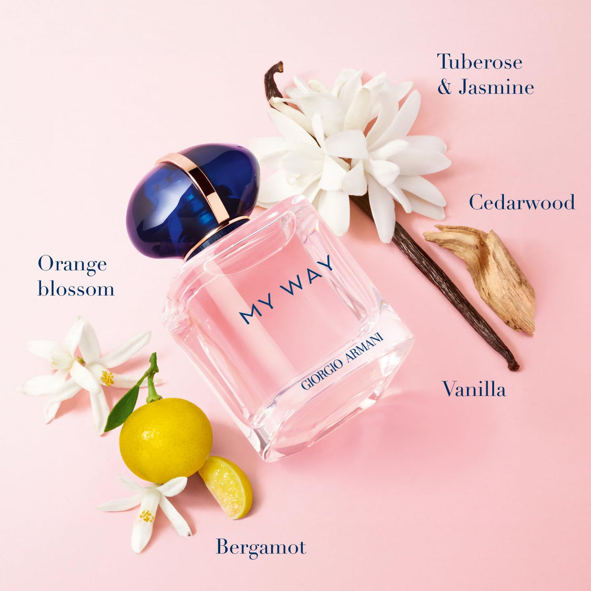 Pink Giorgio Armani perfume bottle with floral elements on a pink background