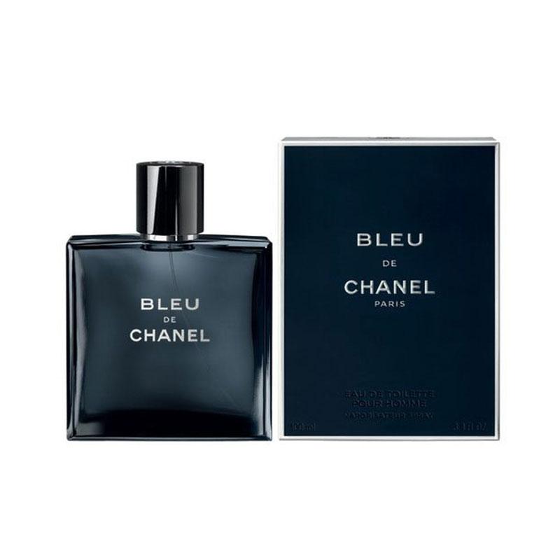 Bleu de Chanel Eau de Toilette perfume bottle in dark navy blue glass next to its matching dark blue box, featuring white lettering on a clean white background.