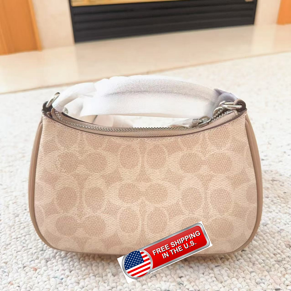 A beige Coach handbag with the signature monogram pattern, shown on a textured light carpet with a fireplace in the background. A red and white 'FREE SHIPPING IN THE U.