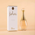 Dior j'adore perfume bottle and packaging on a beige background
