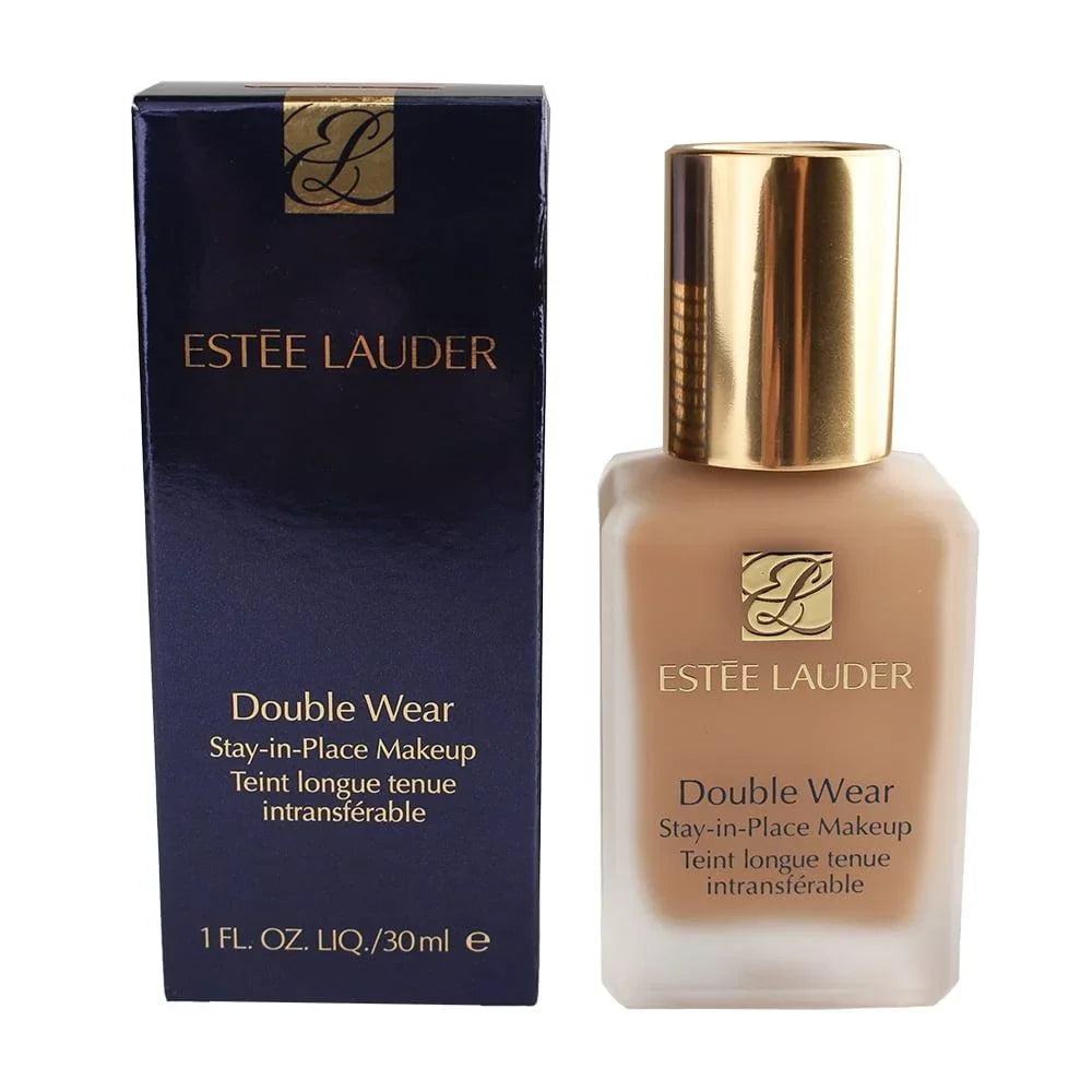 Estée Lauder Double Wear Stay-in-Place Makeup liquid foundation shown with its dark navy blue box and the foundation bottle, which has a gold cap and displays the beige foundation shade.
