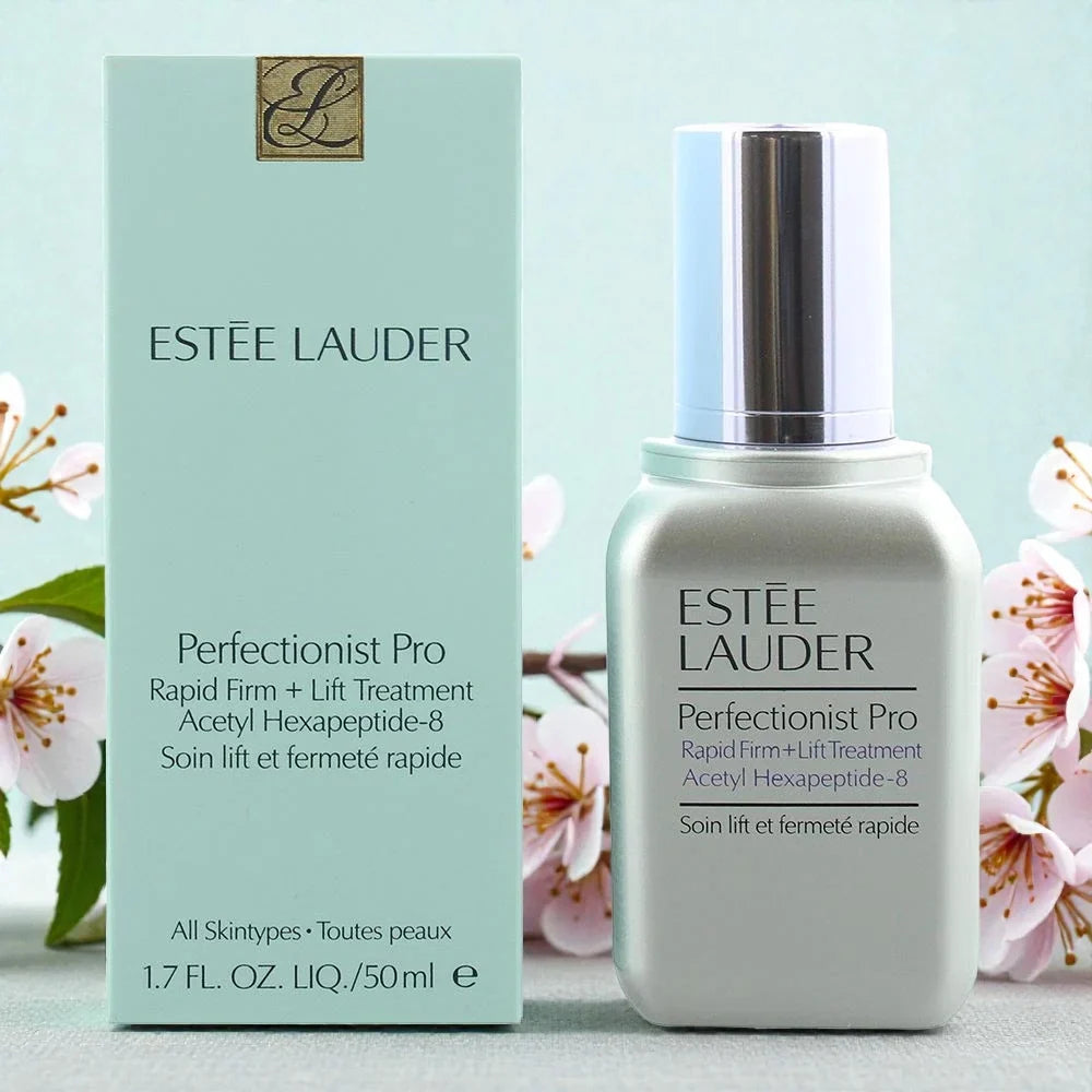 Estée Lauder Perfectionist Pro treatment bottle and packaging with cherry blossoms in the background.