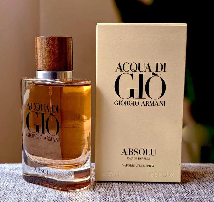 Acqua di Giò Giorgio Armani perfume bottle and packaging on a textured surface.