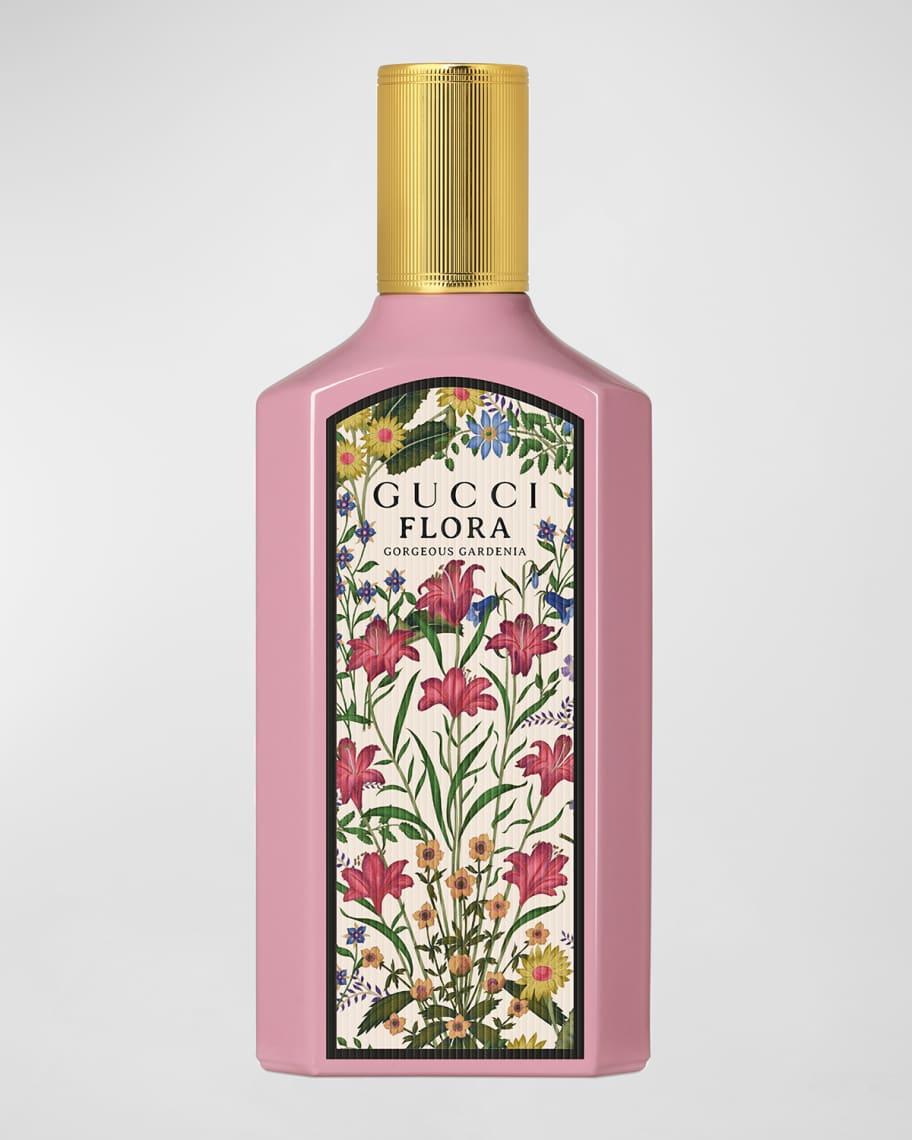 Gucci Flora Conciseur d'Armenia body wash in a pink bottle with a gold cap and a colorful floral label, set against a light gray background.