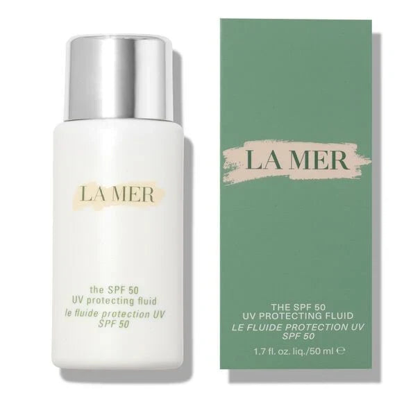 La Mer The SPF 50 UV Protecting Fluid bottle in white with a silver cap, shown next to its green packaging box on a white background.