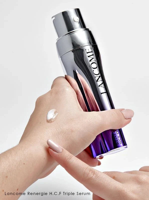 Lancome serum bottle with a hand applying serum on wrist