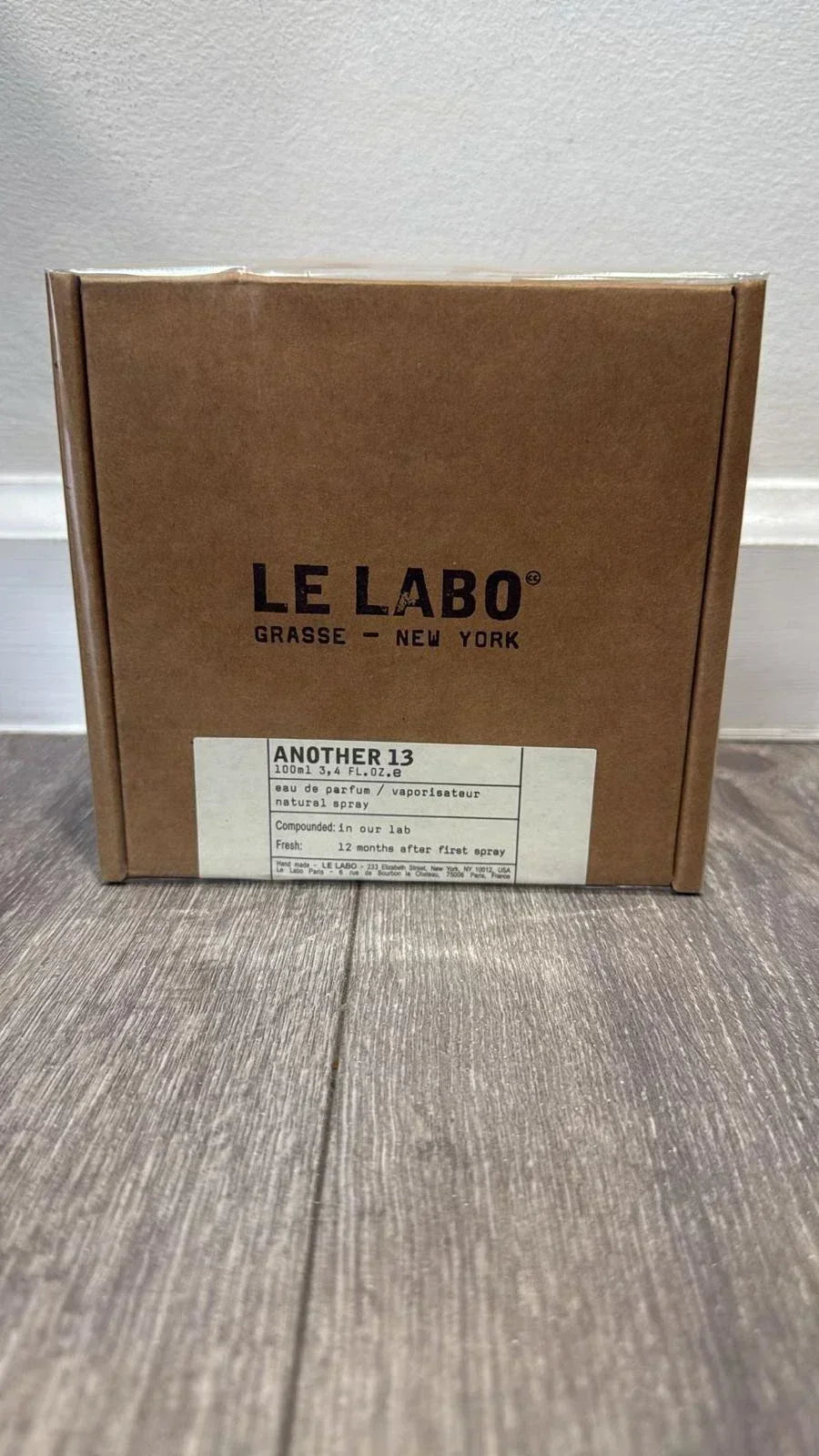 Brown box with 'Le Labo' branding on a wooden surface.