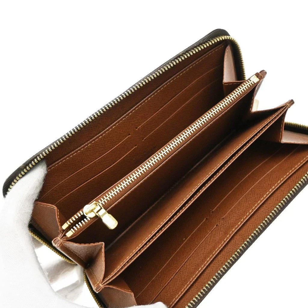 Brown wallet with gold zipper on a white background