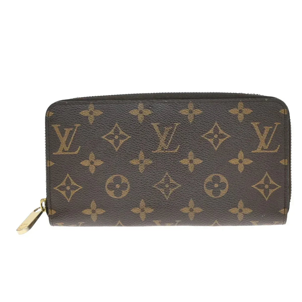 Louis Vuitton monogram canvas zip-around wallet in dark brown with tan monogram motifs and a gold-tone zipper pull, shown on a plain white background.