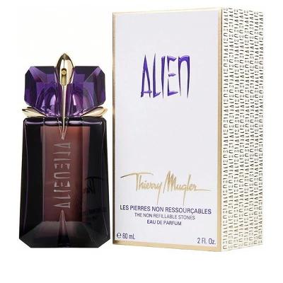 Thierry Mugler Alien perfume bottle and packaging box. The bottle is faceted dark brown glass with a purple gemstone-like cap and gold accents.