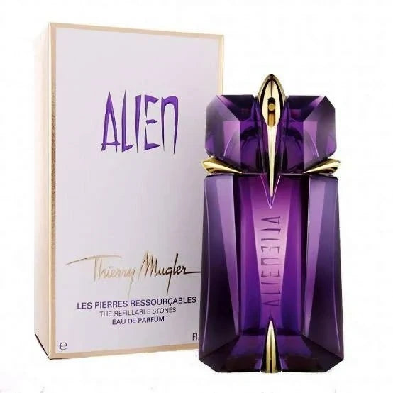 Purple perfume bottle with gold accents and matching box on a white background