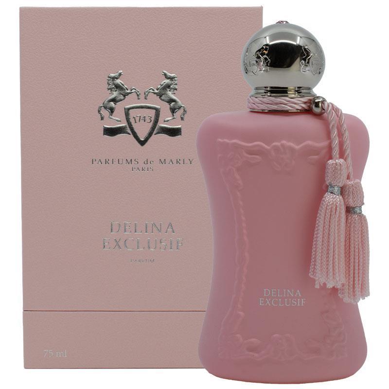 A pink perfume bottle with a silver spherical cap and pink tassel, shown next to its matching pink box. The bottle is embossed with decorative figures and the text 'DELINA EXCLUSIF', and the box shows the Parfums de Marly logo and name.