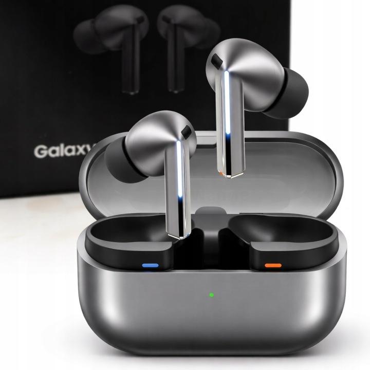 True wireless earbuds with a metallic silver finish and black ear tips, shown in an open charging case with a black box in the background.
