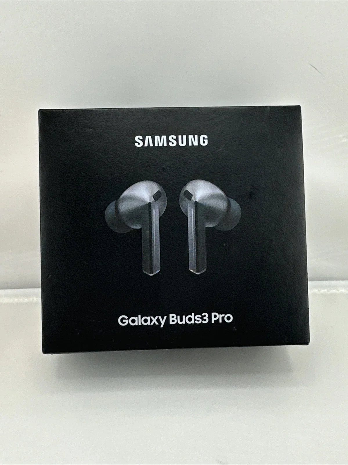 Samsung Galaxy Buds3 Pro wireless earbuds retail box in black, featuring a printed graphic of the silver and black earbuds on the front, with the SAMSUNG brand name and model name visible.