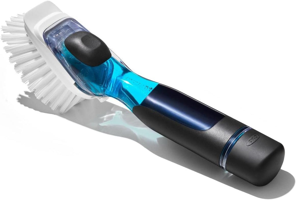 A modern electric dishwashing brush with a white bristle head, a translucent blue and black handle, and a black ergonomic grip, shown on a white background with a soft shadow.
