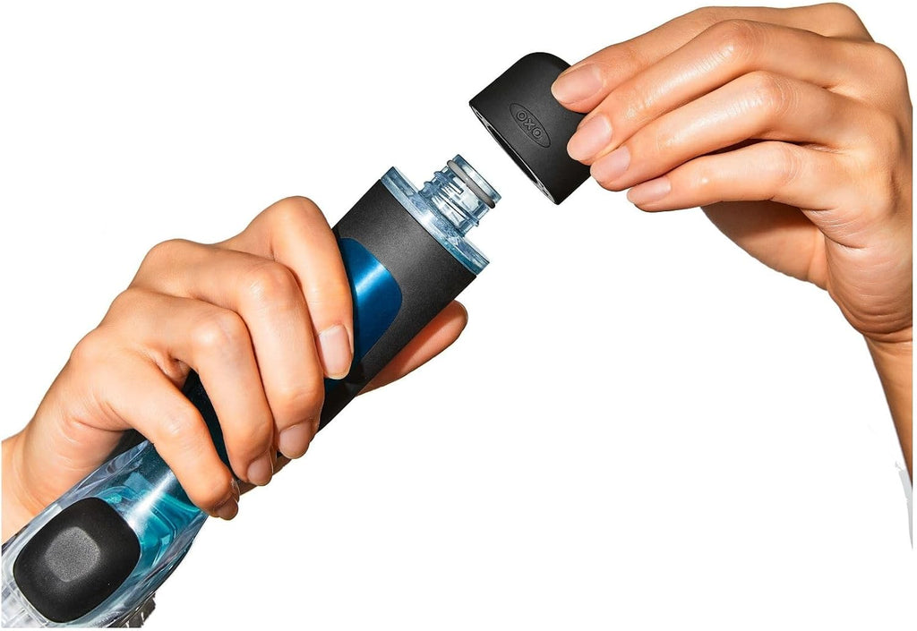Person opening a blue and black water bottle with a white background