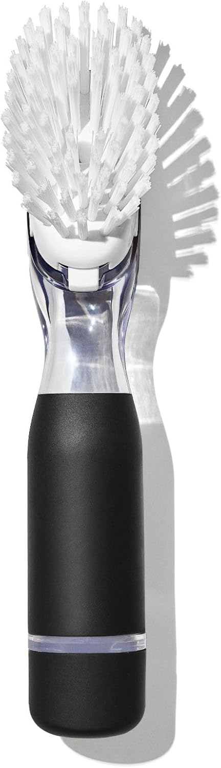 A handheld electric cleaning brush with a black handle, clear neck, and white bristles, shown on a white background with a soft shadow.