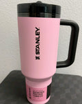A pink Stanley Quencher ProTour tumbler with a black handle and lid, featuring the black Stanley logo on the front, set against a neutral background.