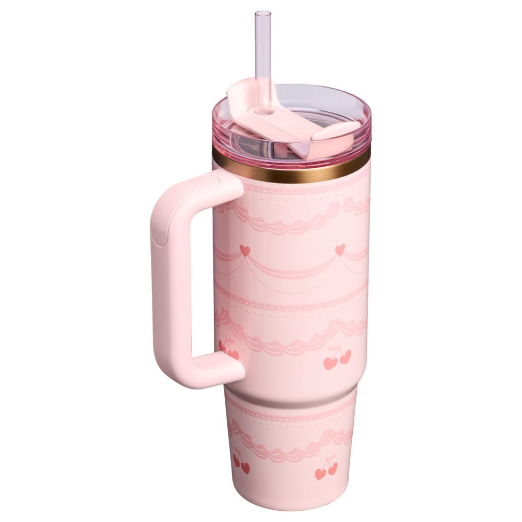 Pink tumbler with handle and straw on a white background
