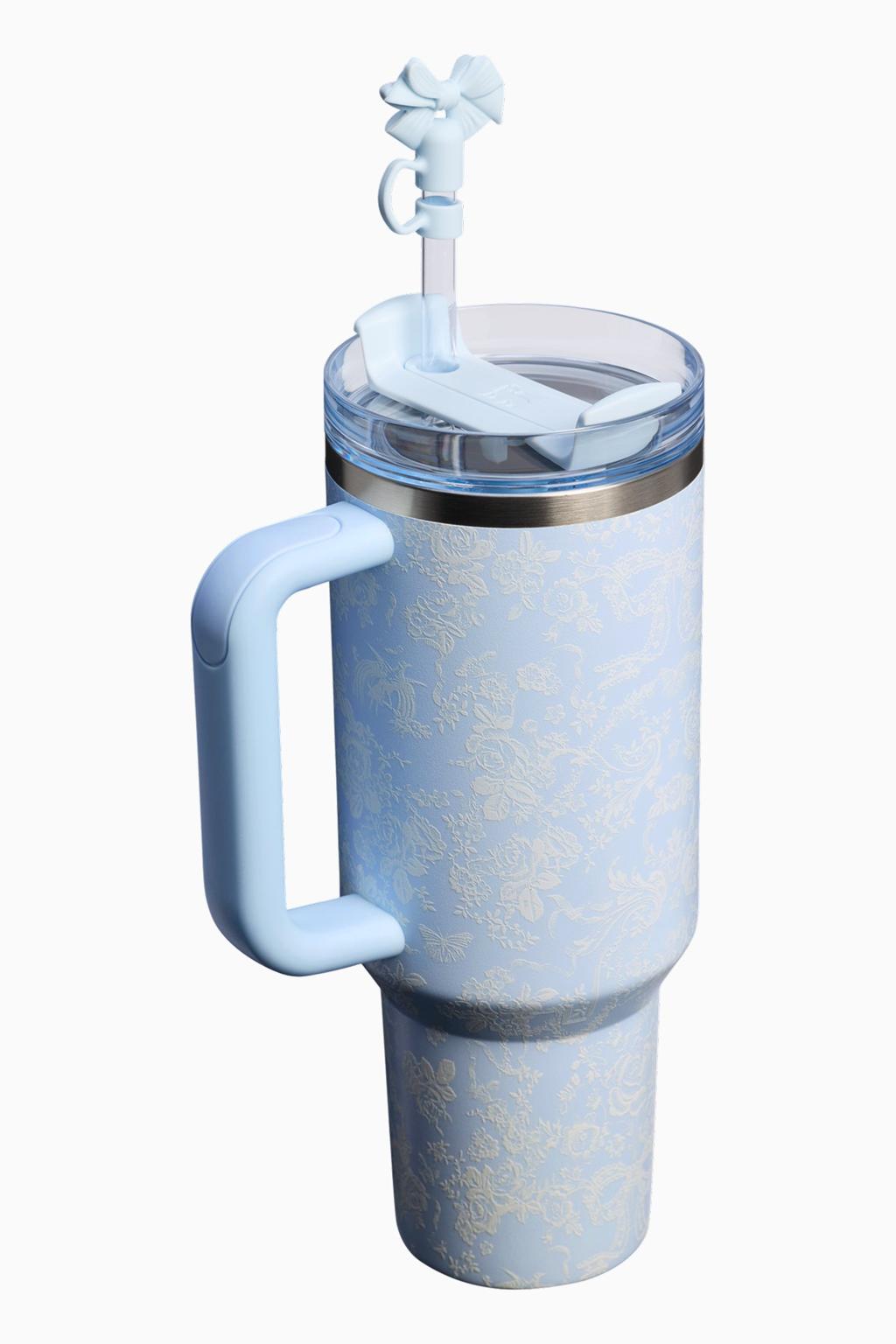 Blue insulated tumbler with handle and straw on a white background