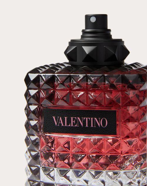 Valentino perfume bottle with black cap on a light gray background