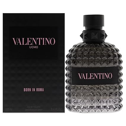 Valentino Uomo Born in Roma fragrance shown with its black textured box and the bottle itself. The bottle is made of faceted dark gray glass with a black cap and a black label featuring pink lettering.