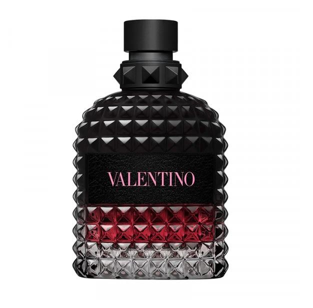 Valentino Uomo fragrance bottle with a textured black cap and body, featuring a black label with pink 'VALENTINO' text and a red gradient lower section, on a white background.