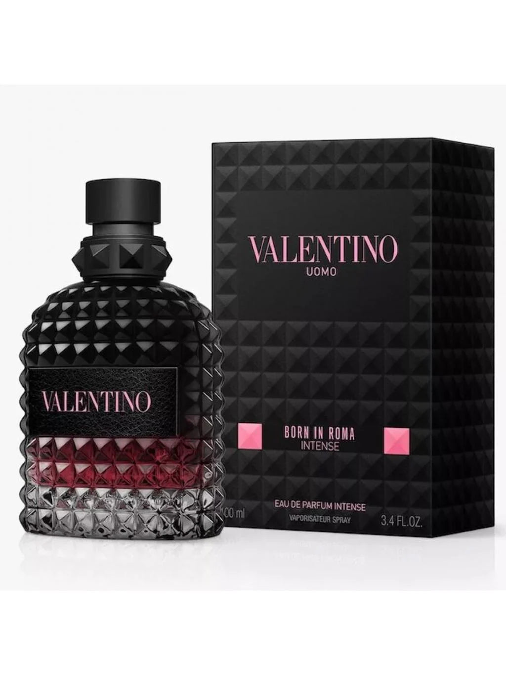 Valentino Uomo Born in Roma Intense Eau de Parfum Intense bottle with a textured black cap and base, showing a deep red liquid inside, next to its black geometric packaging box with pink lettering.